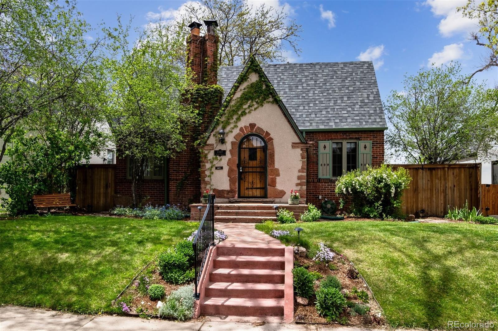 1377 Cherry Street Denver, CO 80220 - Photo 1 of 50 a front view of a house with a yard