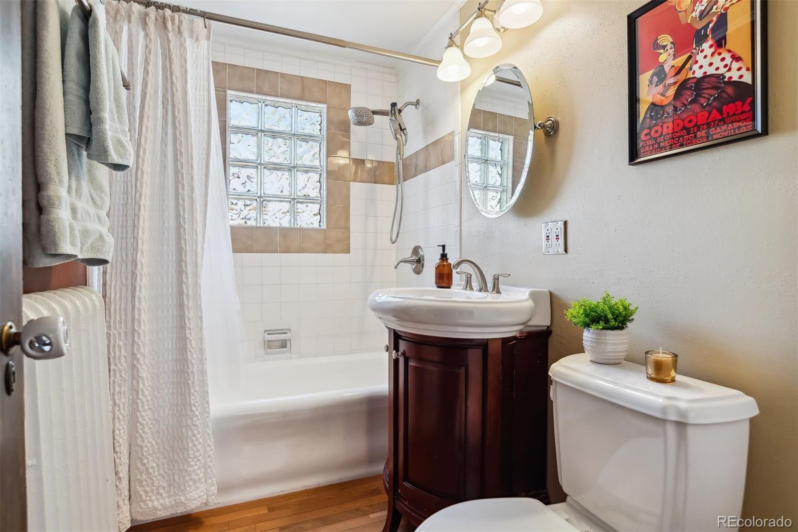 1377 Cherry Street Denver, CO 80220 - Photo 21 of 50 a bathroom with a sink mirror and toilet
