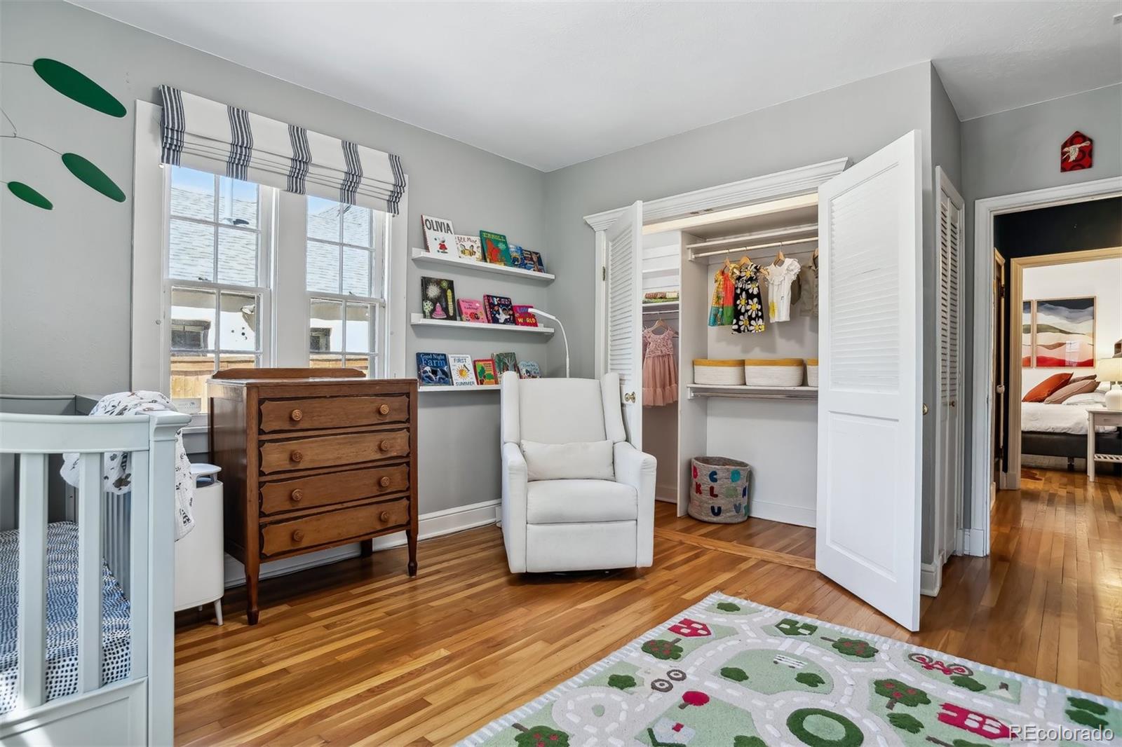 1377 Cherry Street Denver, CO 80220 - Photo 23 of 50 a bedroom with a bed and a window