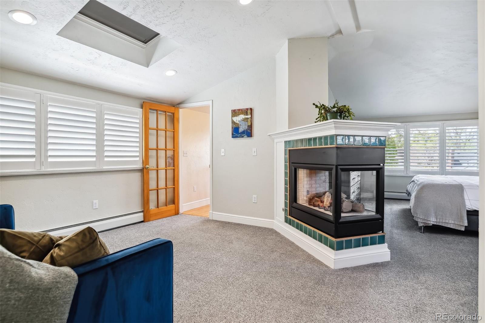 1377 Cherry Street Denver, CO 80220 - Photo 27 of 50 a living room with furniture and a fireplace