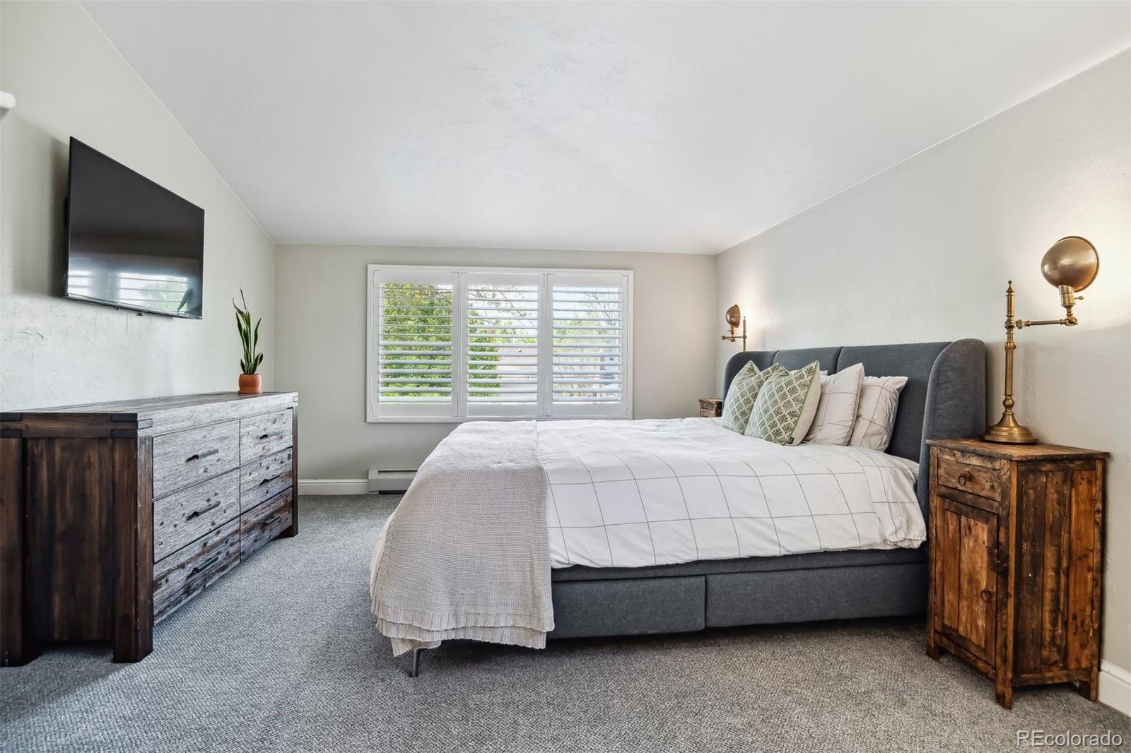 1377 Cherry Street Denver, CO 80220 - Photo 28 of 50 a spacious bedroom with a bed and a flat screen tv