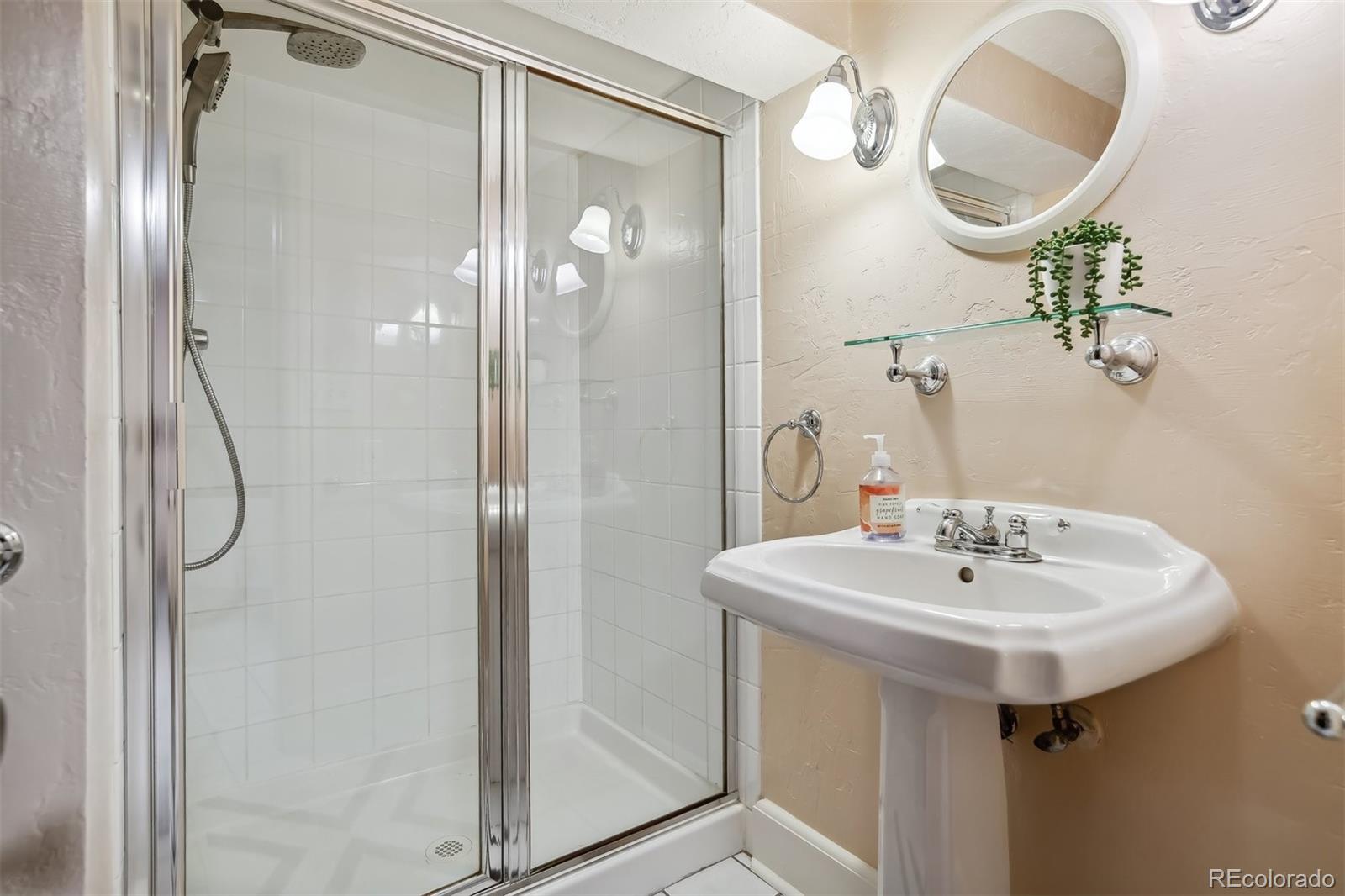 1377 Cherry Street Denver, CO 80220 - Photo 38 of 50 a bathroom with a sink and a mirror