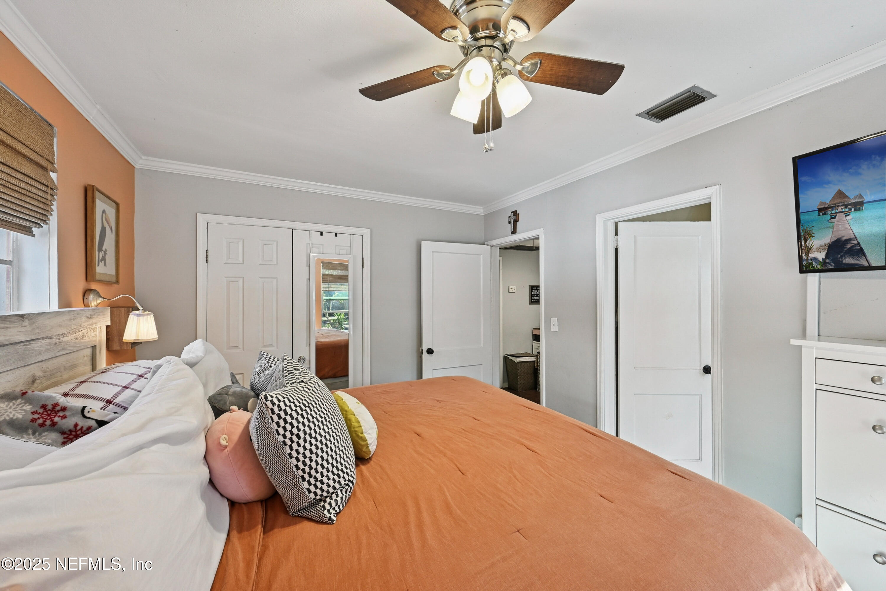1316 Rensselaer Avenue Jacksonville, FL 32205 - Photo 25 of 46 a bedroom with a large bed and a chandelier