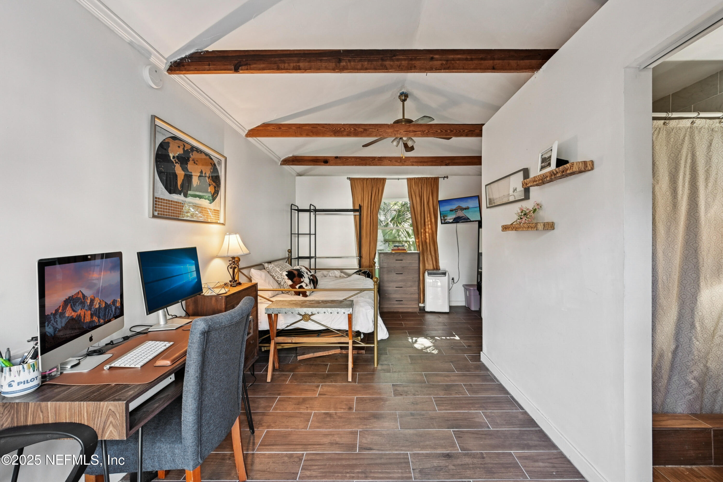 1316 Rensselaer Avenue Jacksonville, FL 32205 - Photo 30 of 46 a living room with furniture a flat screen tv and a fireplace