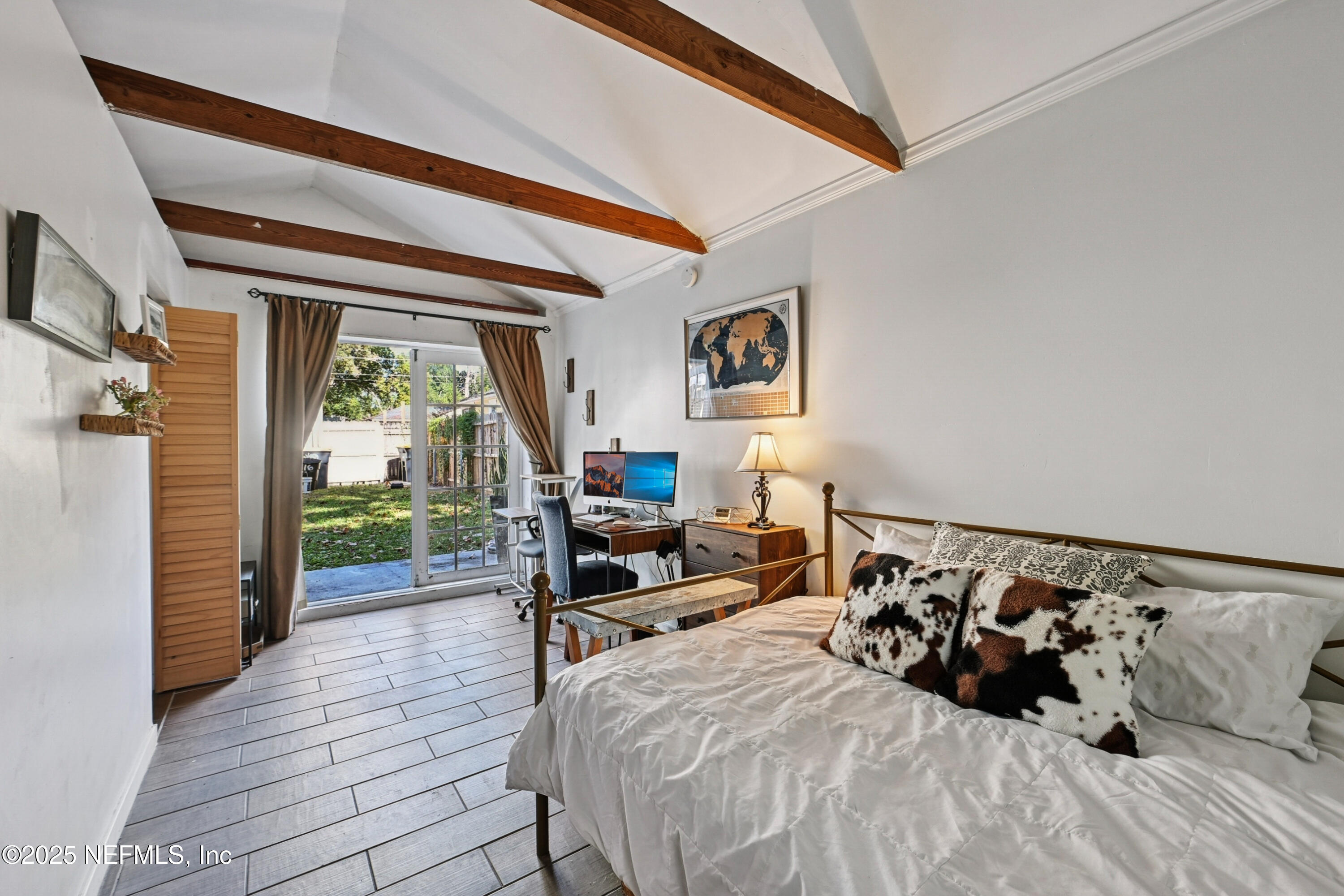 1316 Rensselaer Avenue Jacksonville, FL 32205 - Photo 31 of 46 a bedroom with a bed and wooden floor