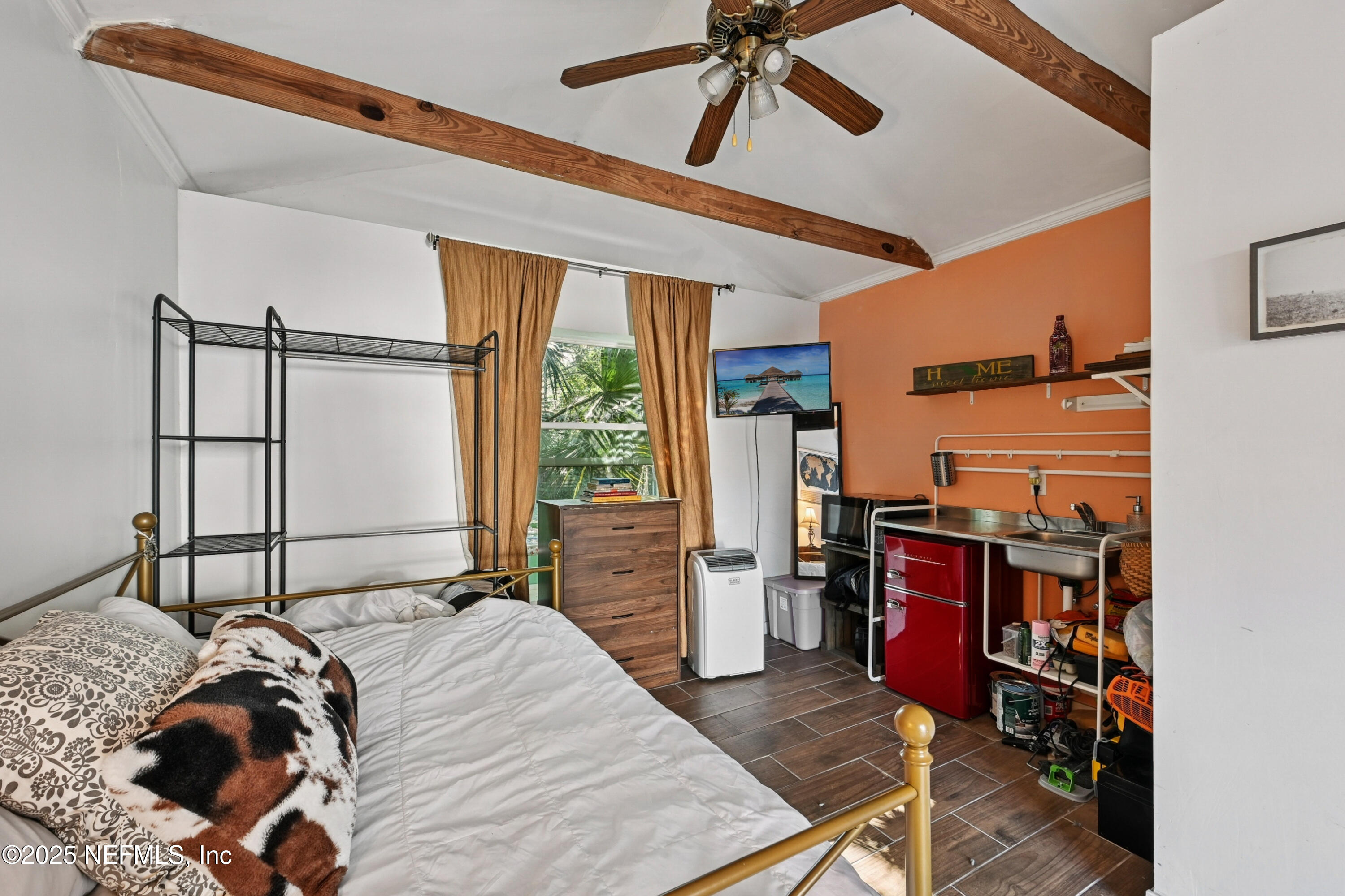 1316 Rensselaer Avenue Jacksonville, FL 32205 - Photo 32 of 46 a bed sitting in a bedroom next to a window