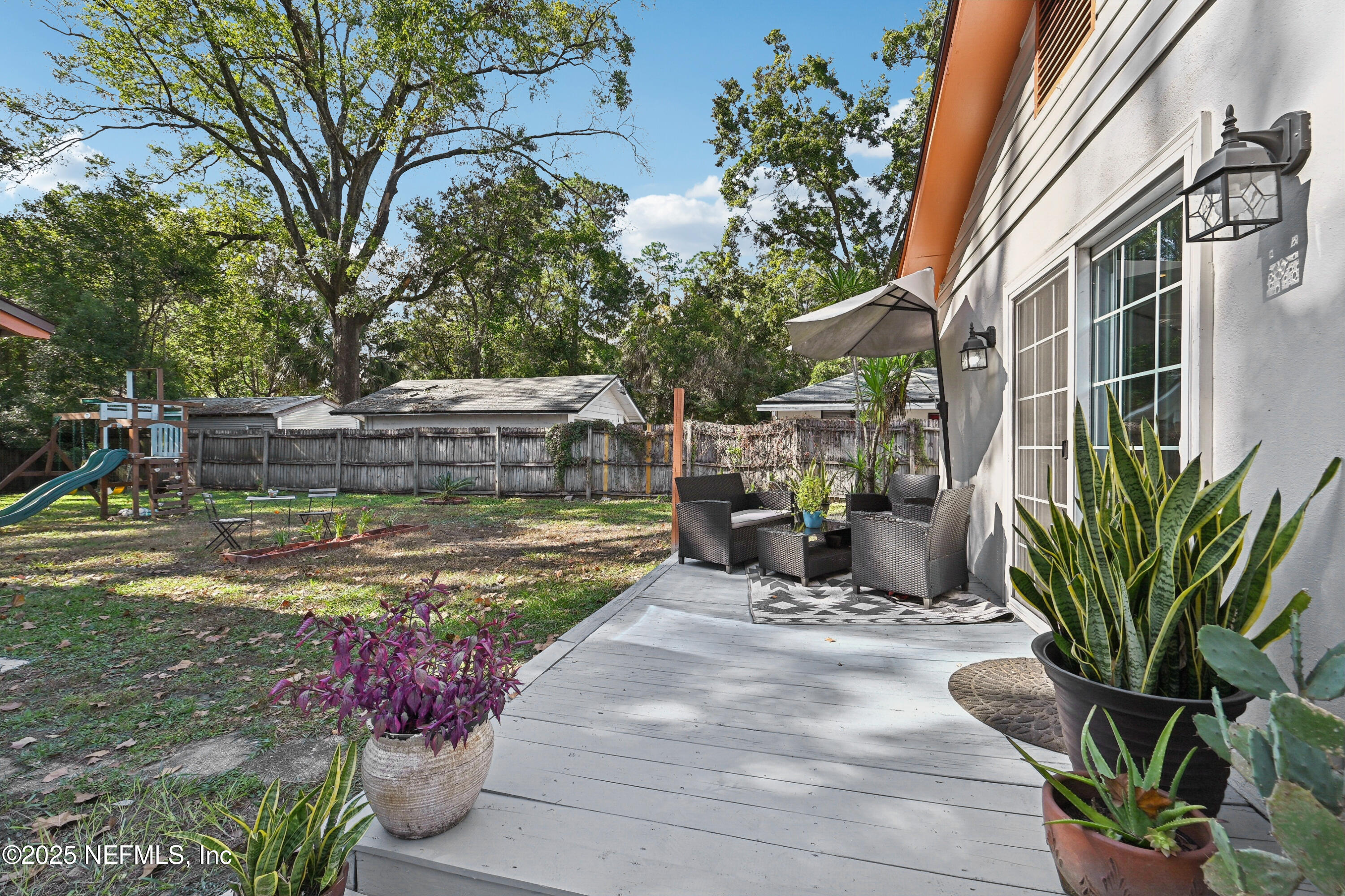 1316 Rensselaer Avenue Jacksonville, FL 32205 - Photo 34 of 46 a view of a chair and tables in the backyard of a house