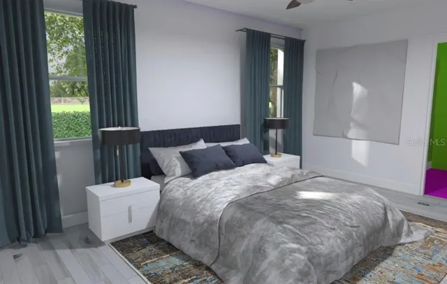 a bed sitting in a bedroom next to a window