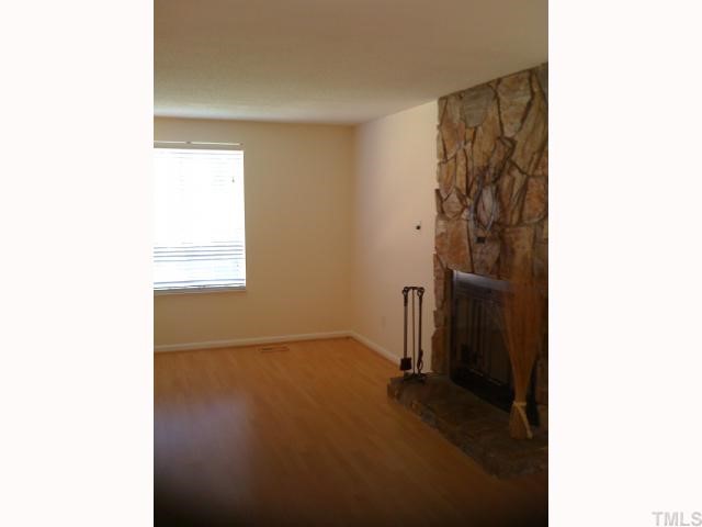 2532 Boothbay Court Raleigh, NC 27613 - Photo 4 of 12 The living room with gleaming laminate floors features a beautiful working stone fireplace