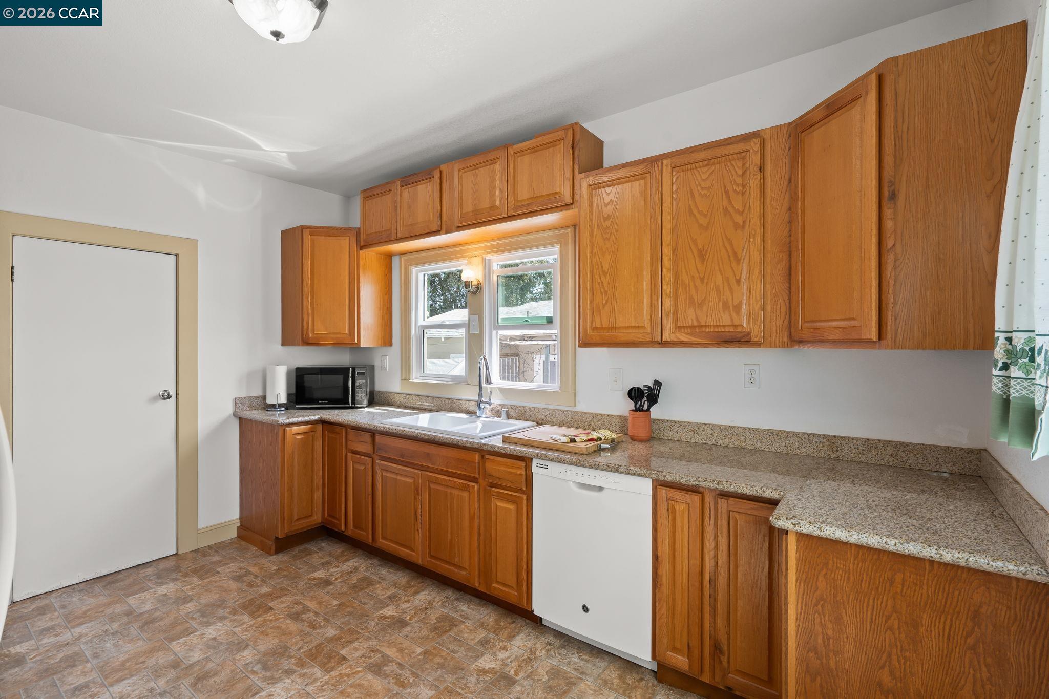 272 West 10th Street Pittsburg, CA 94565 - Photo 12 of 29 a kitchen with stainless steel appliances granite countertop a sink stove and cabinets