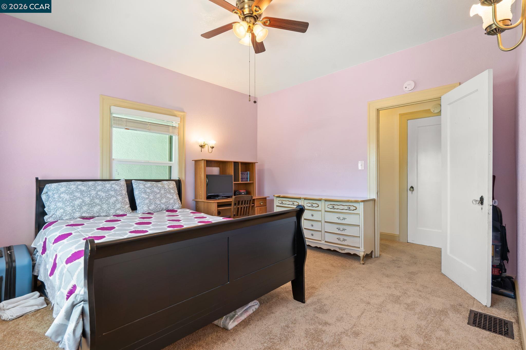 272 West 10th Street Pittsburg, CA 94565 - Photo 15 of 29 a bed room with a bed and a television