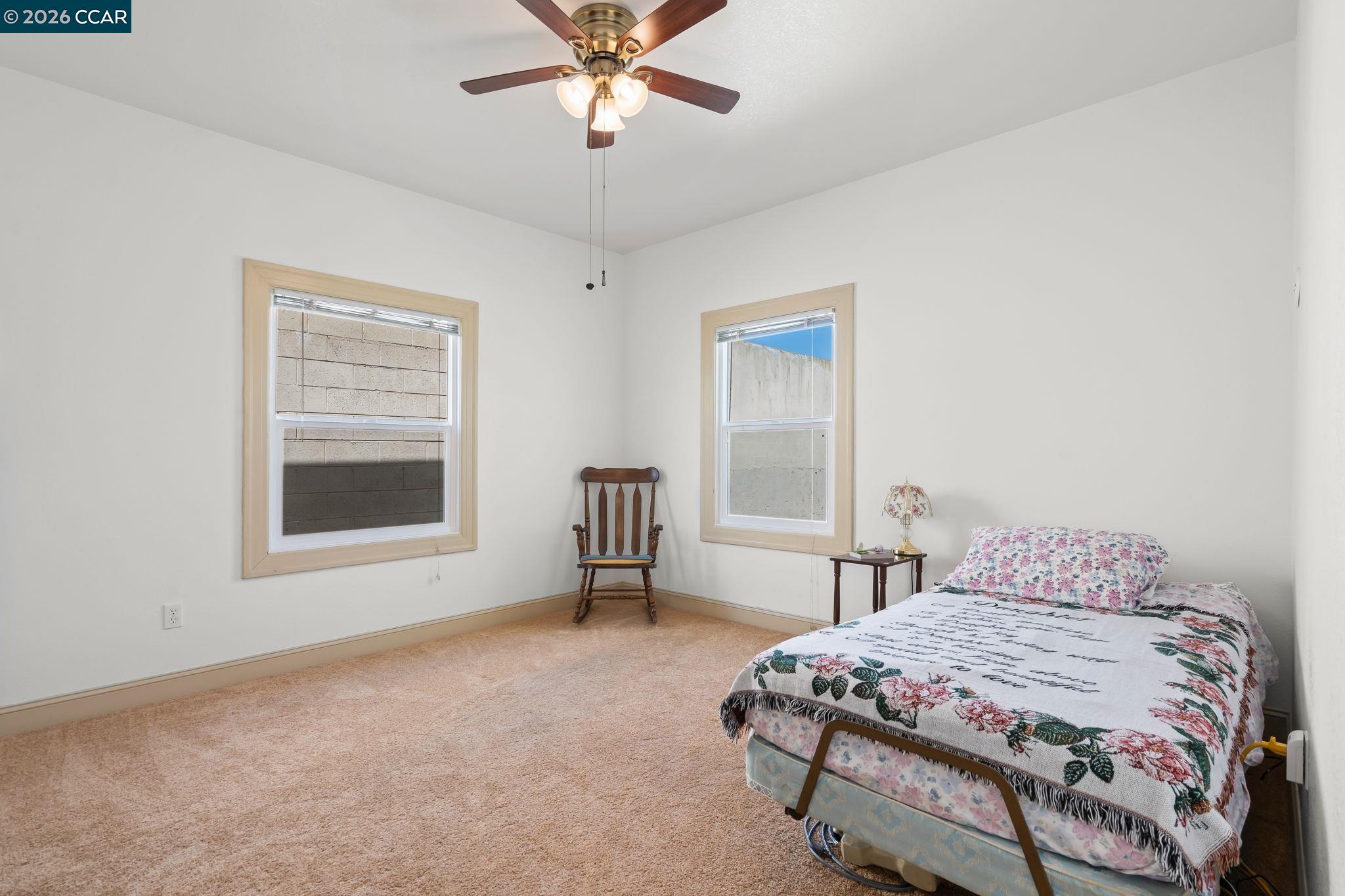 272 West 10th Street Pittsburg, CA 94565 - Photo 17 of 29 a bedroom with a bed and a window