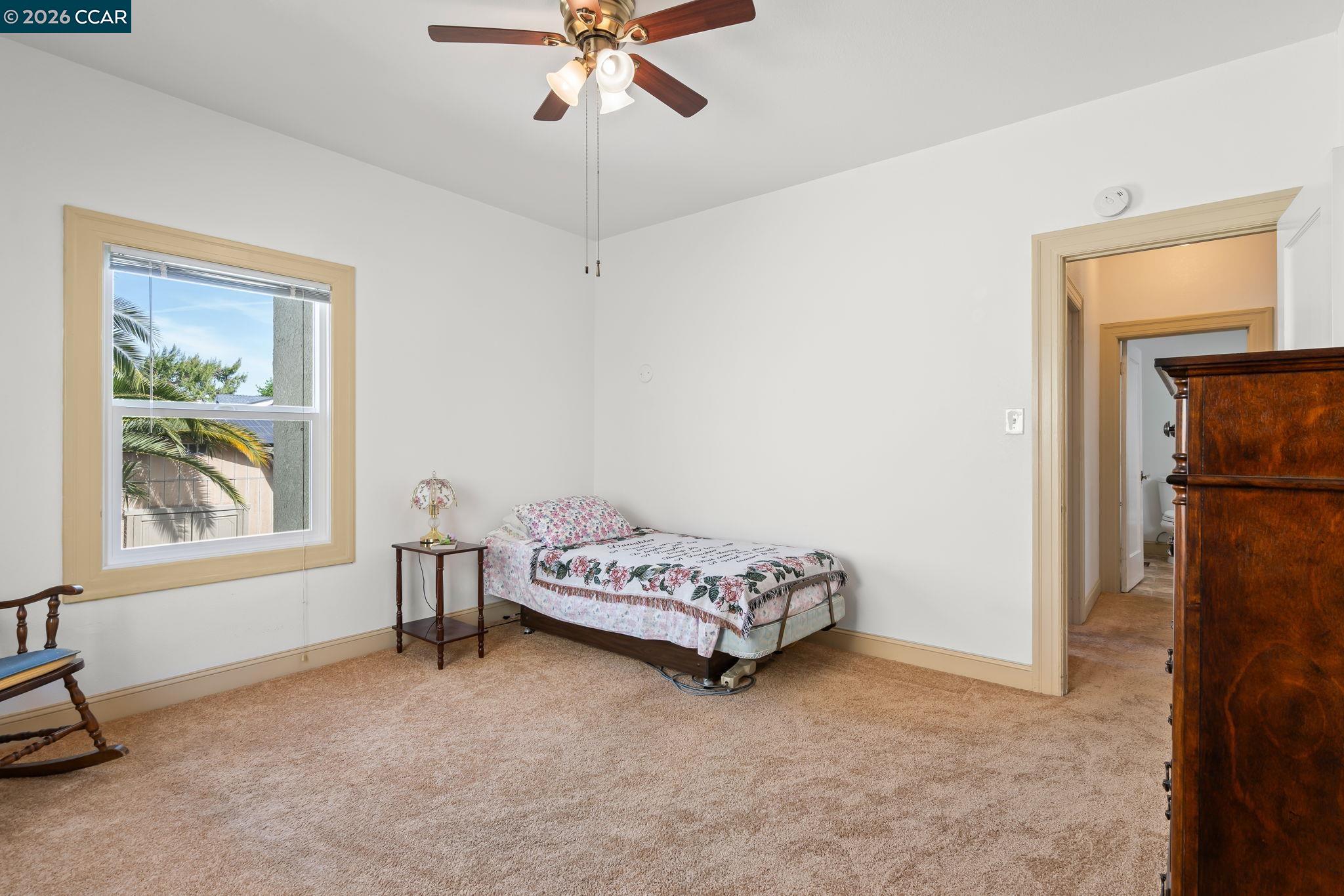 272 West 10th Street Pittsburg, CA 94565 - Photo 19 of 29 a bedroom with a bed and a window