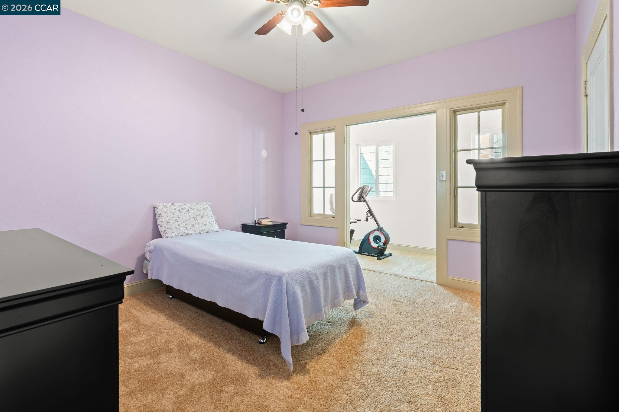 272 West 10th Street Pittsburg, CA 94565 - Photo 20 of 29 a bedroom with a bed and a chandelier