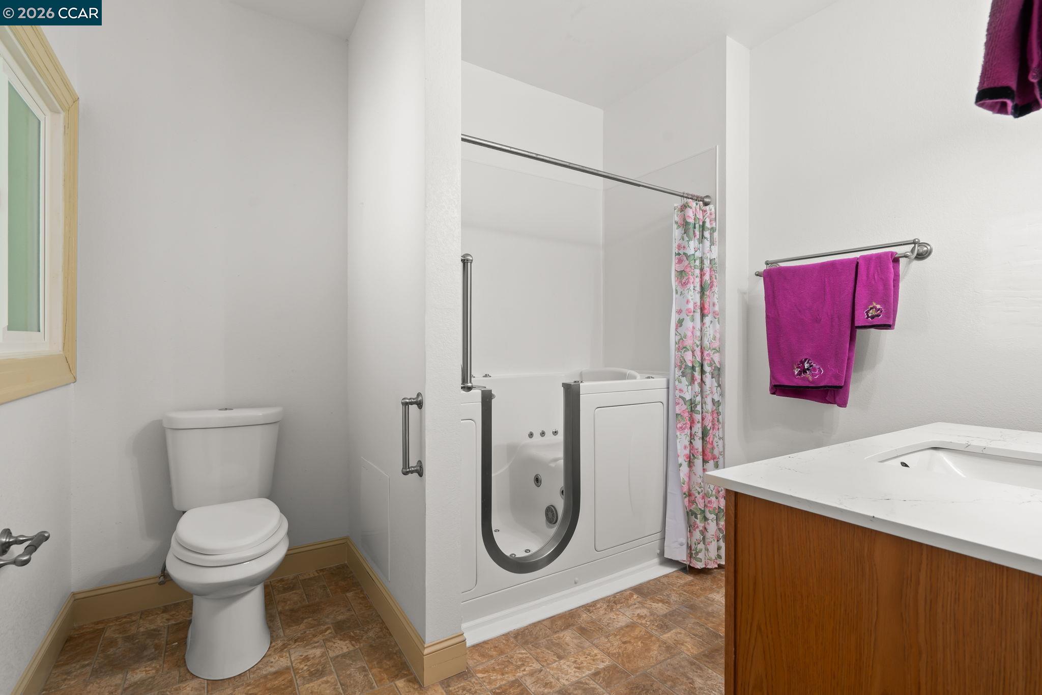 272 West 10th Street Pittsburg, CA 94565 - Photo 23 of 29 a bathroom with a toilet and a shower