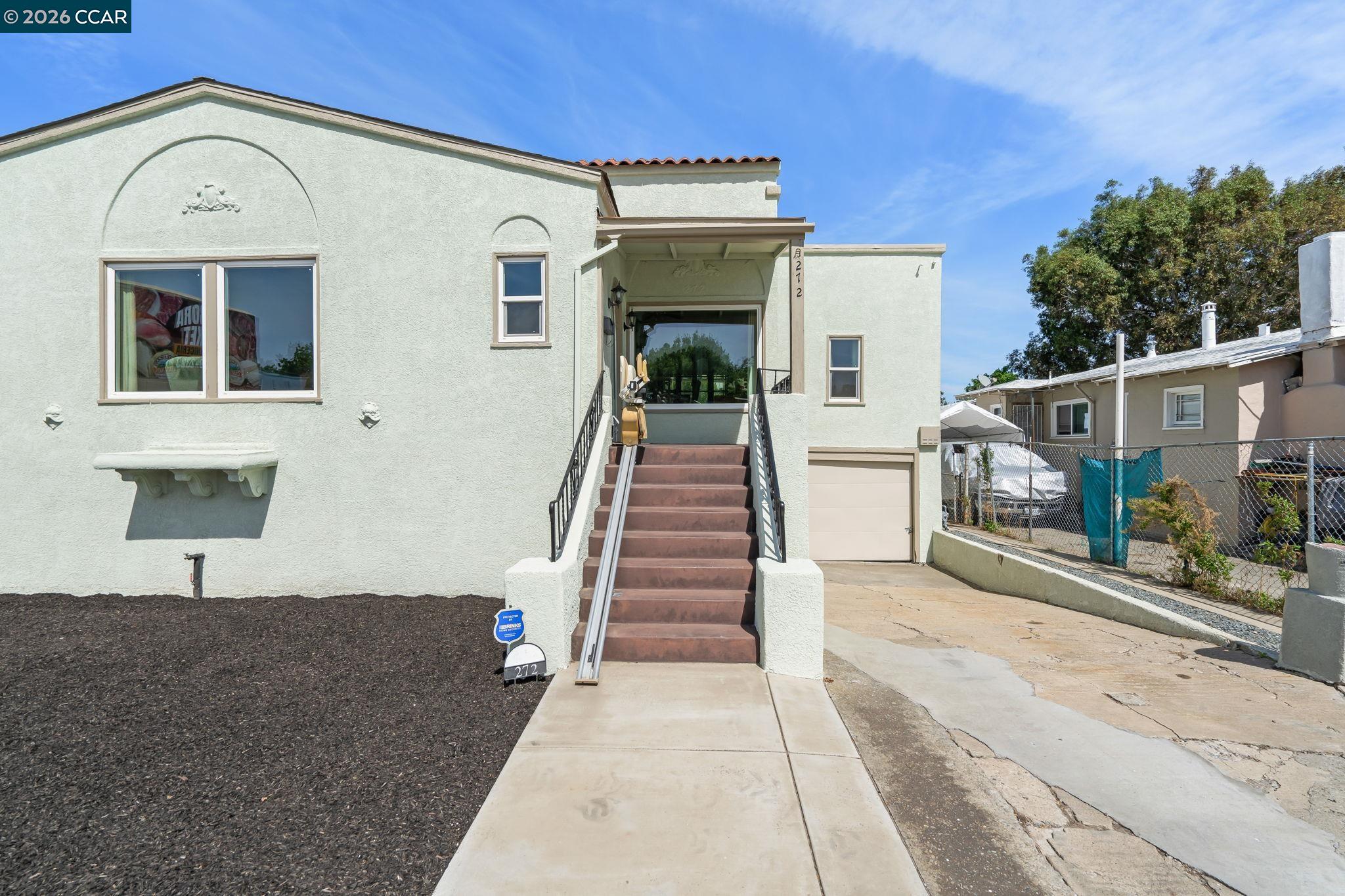 272 West 10th Street Pittsburg, CA 94565 - Photo 3 of 29 a front view of a house with stairs