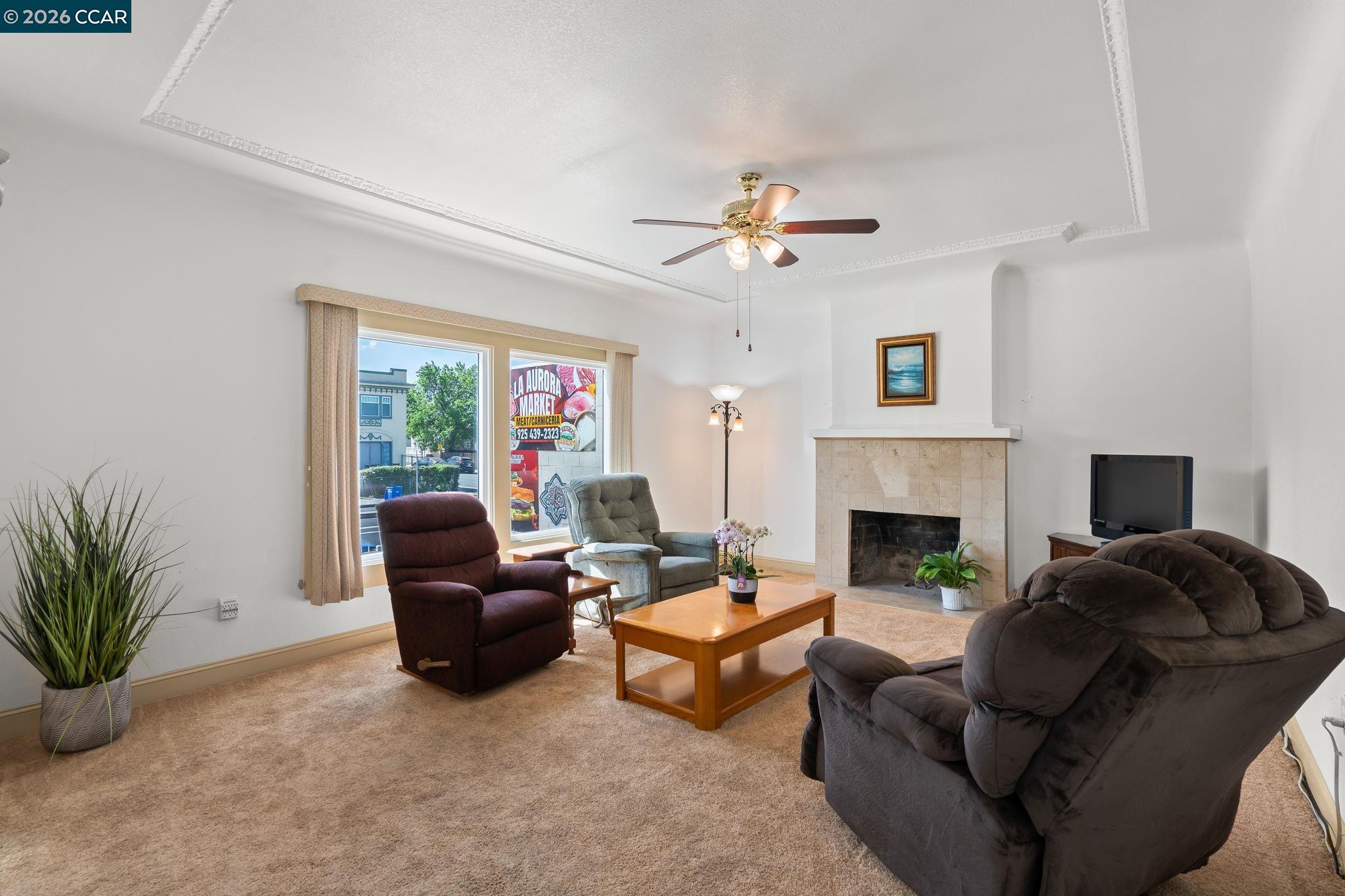 272 West 10th Street Pittsburg, CA 94565 - Photo 7 of 29 a living room with furniture and a fireplace