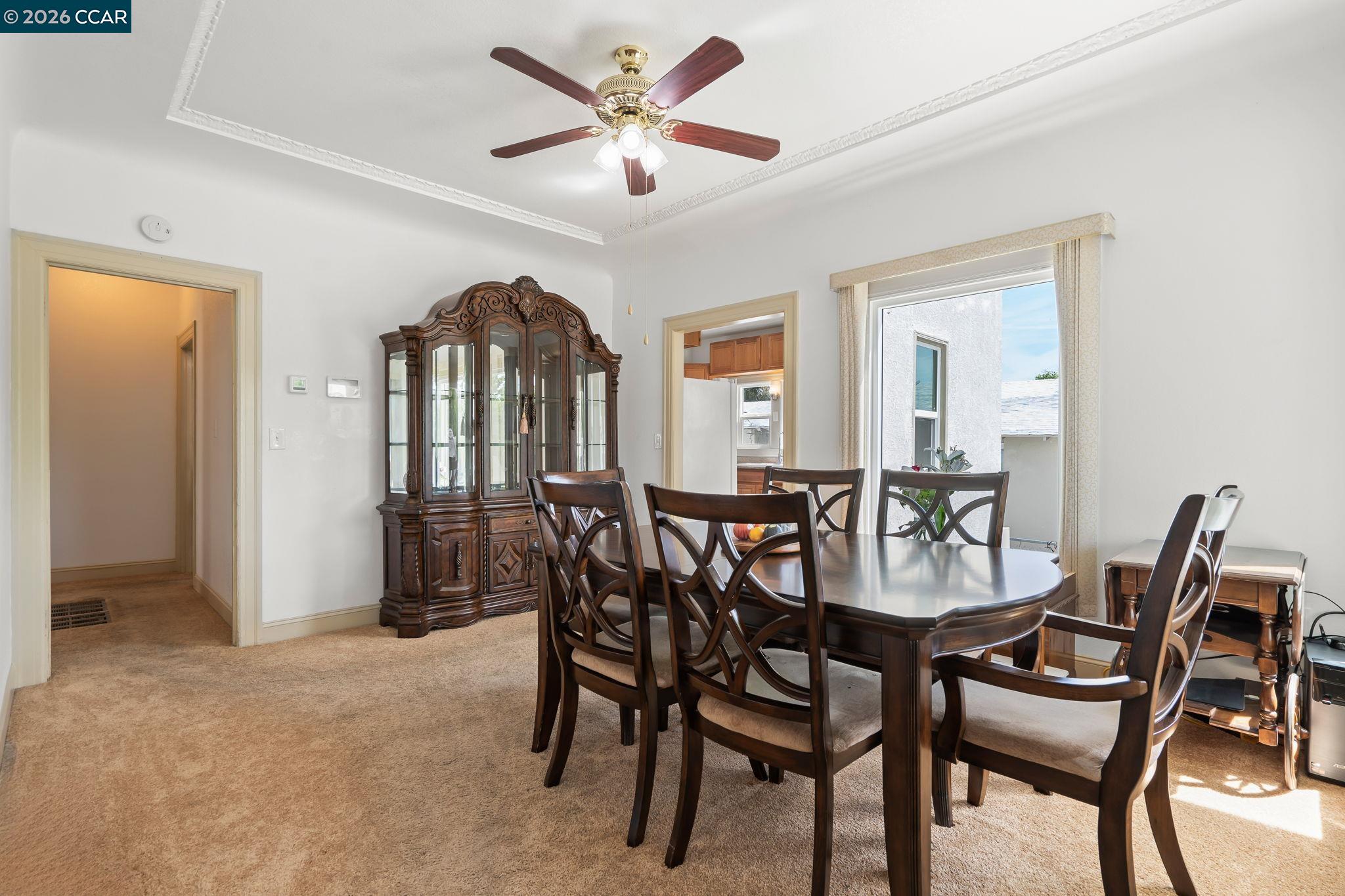 272 West 10th Street Pittsburg, CA 94565 - Photo 9 of 29 a view of a dining room with furniture and a chandelier fan