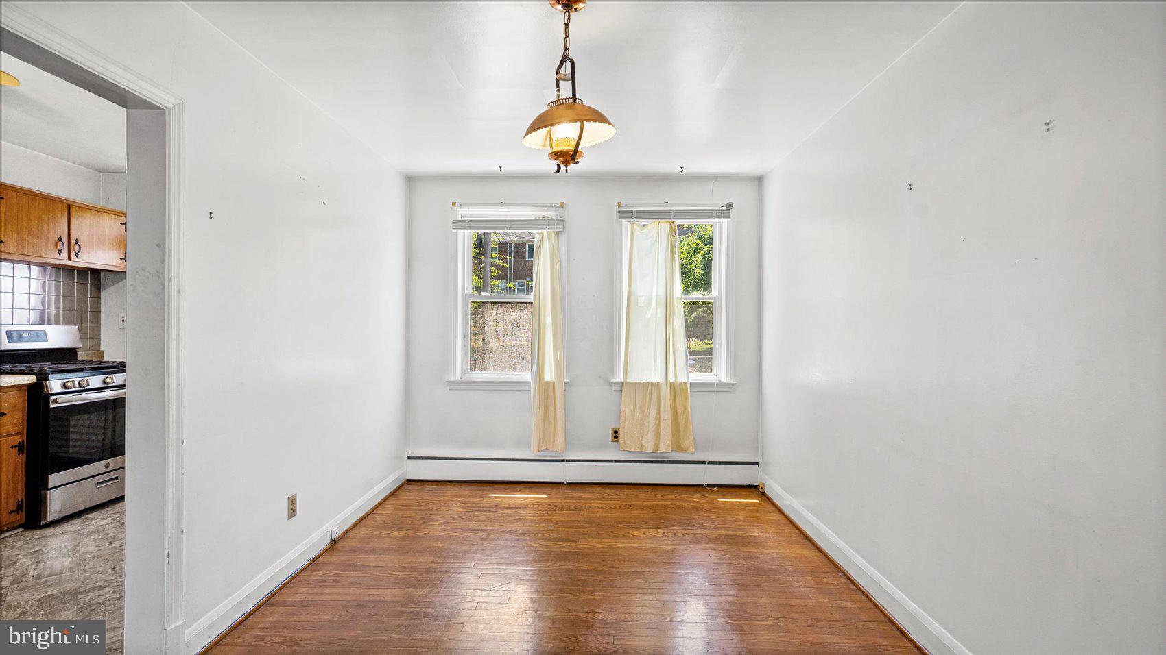 1805 Crestview Road Baltimore, MD 21239 - Photo 10 of 39 a view of empty room with wooden floor and windows