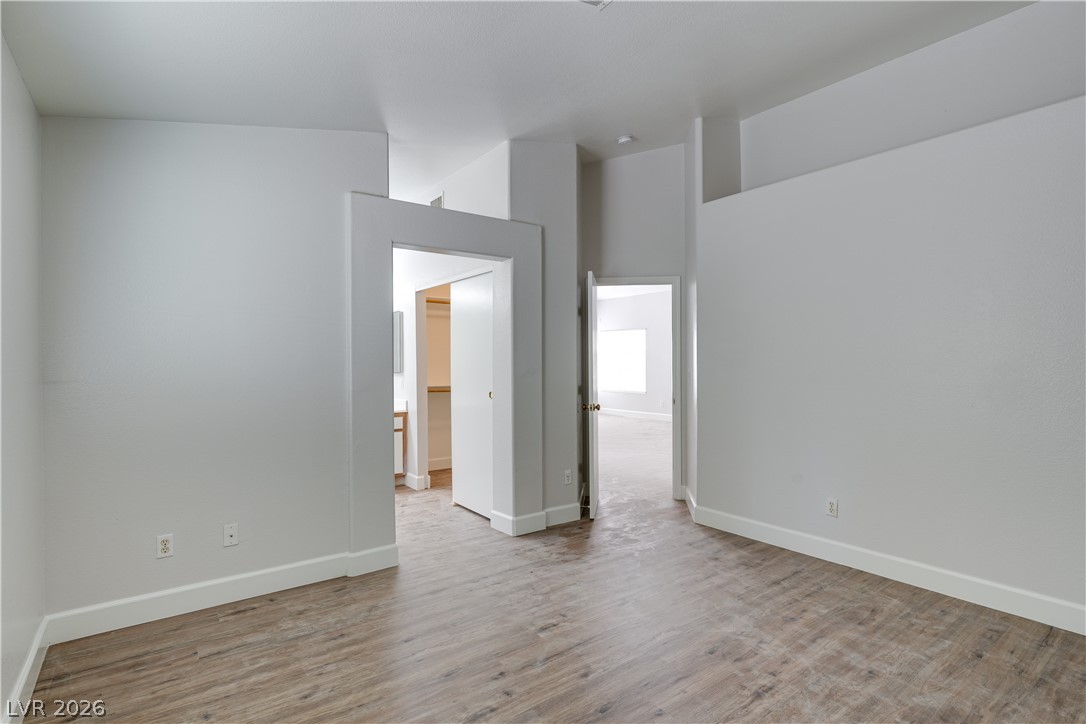 9660 Crystal Ridge Road Las Vegas, NV 89123 - Photo 10 of 13 Laminate wood flooring creates a welcoming ambiance throughout this versatile open-plan interior.