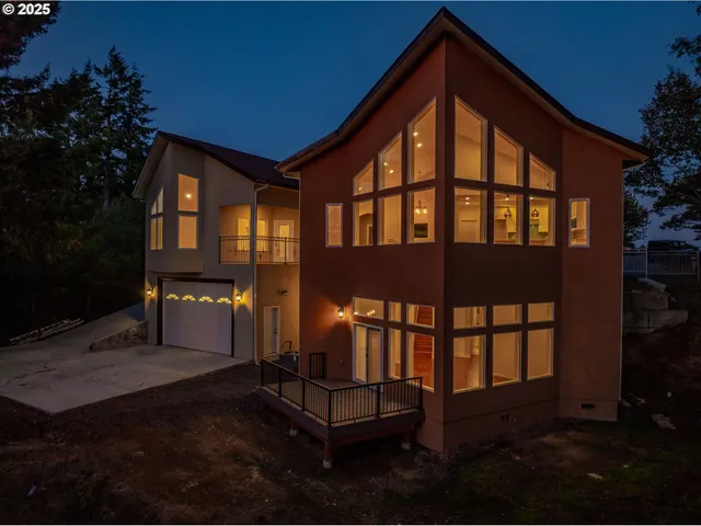 a backyard of a house with table and chairs