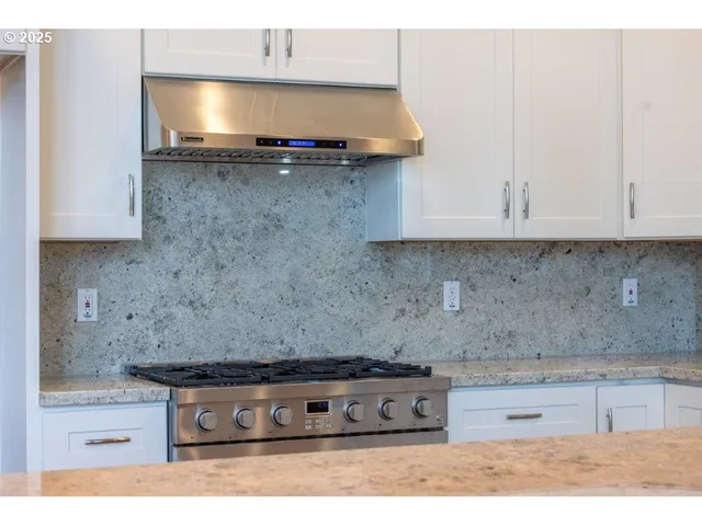 a kitchen with stainless steel appliances granite countertop a granite counter tops and a stove