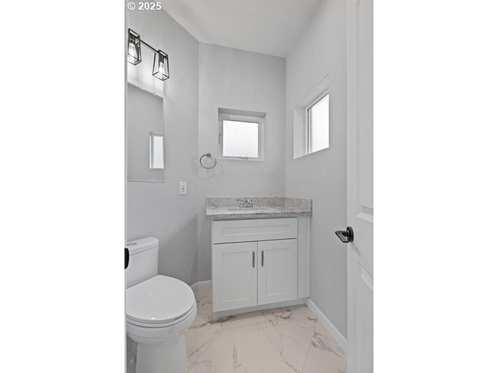 2495 Chester Street North Bend, OR 97459 - Photo 31 of 48 a bathroom with a sink toilet and vanity