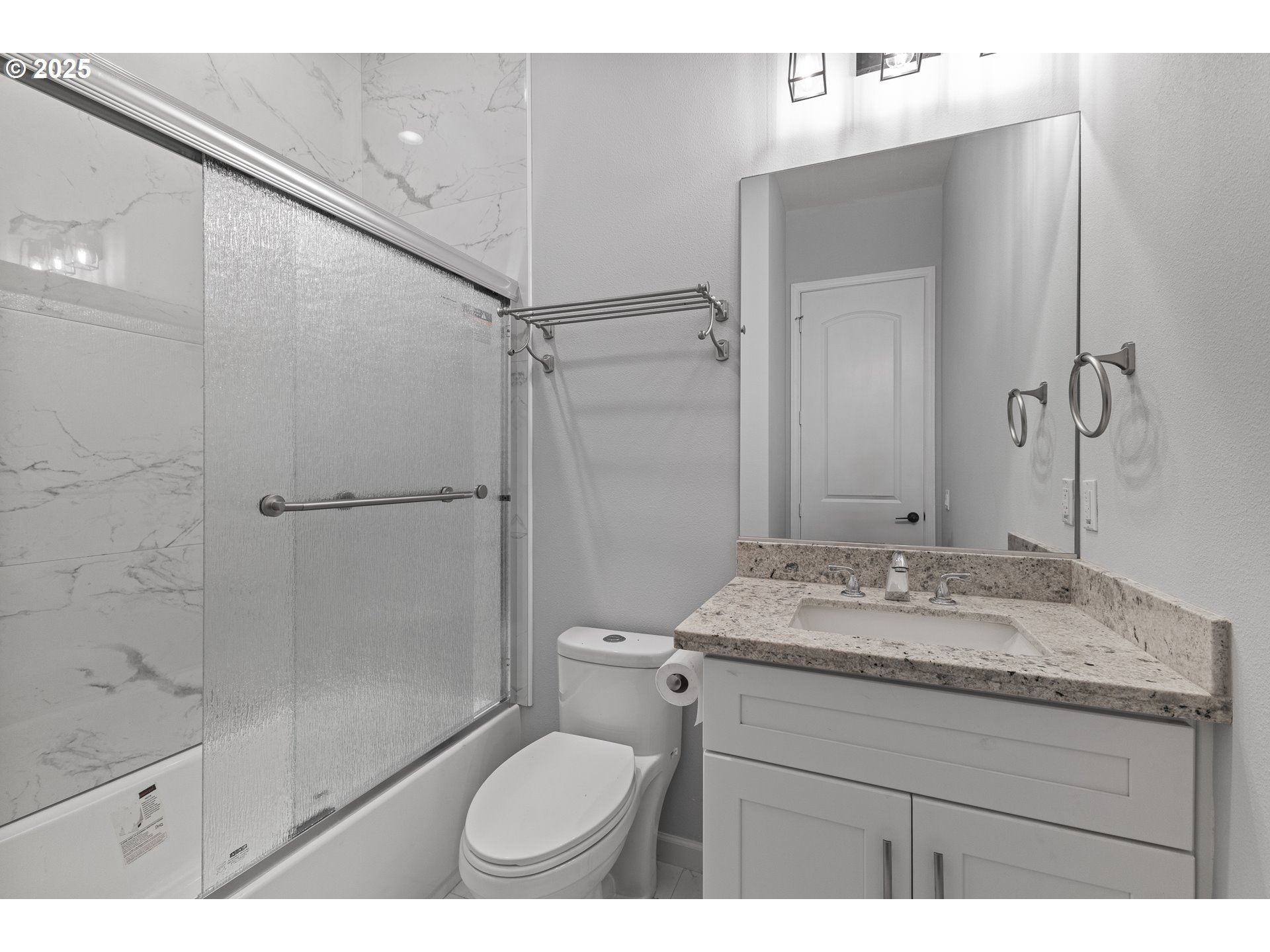 2495 Chester Street North Bend, OR 97459 - Photo 41 of 48 a bathroom with a granite countertop sink toilet a mirror and shower