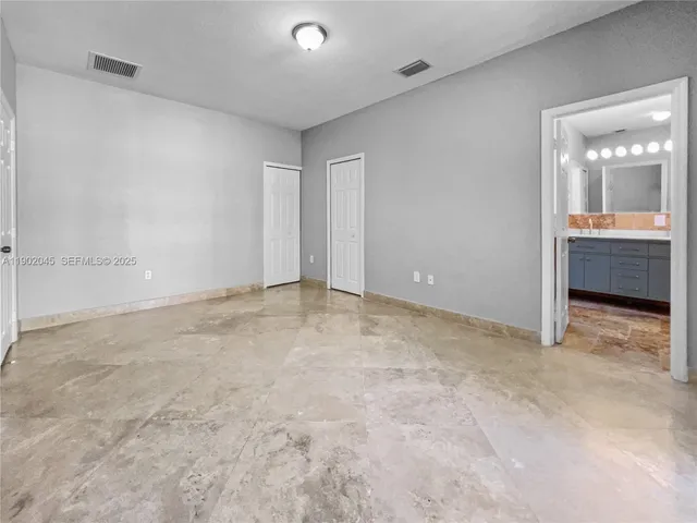 a bathroom with a granite countertop sink a mirror and a bathtub