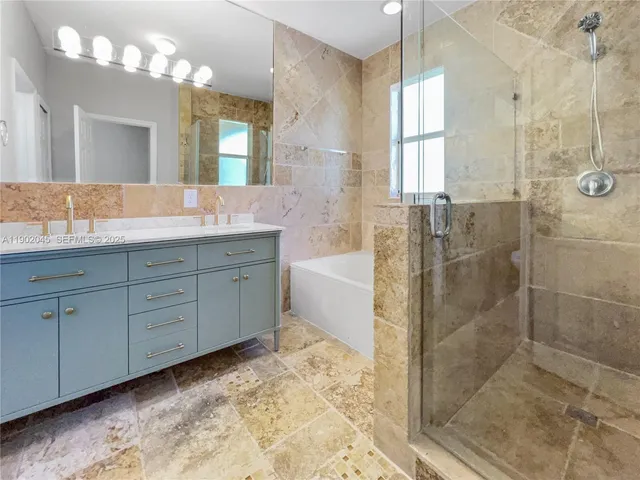 a spacious bathroom with a granite countertop sink a toilet and a mirror
