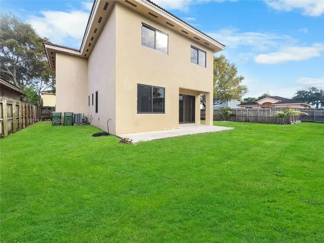 a backyard of a house with lots of green space
