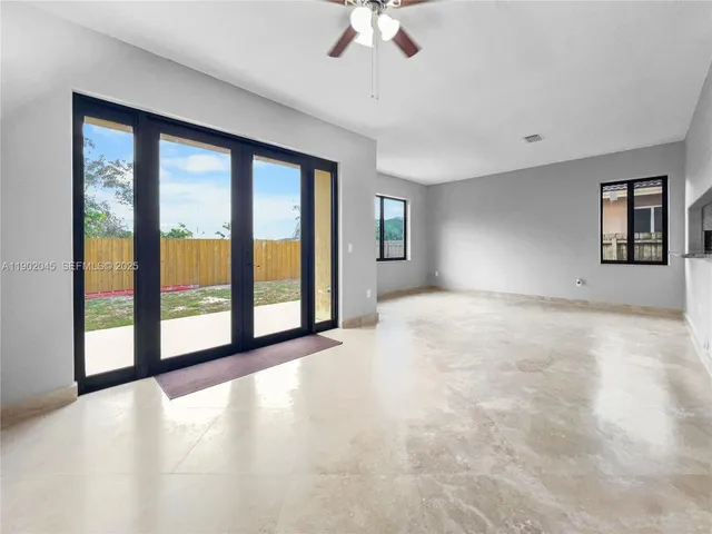 a view of a livingroom with wooden floor and kitchen space