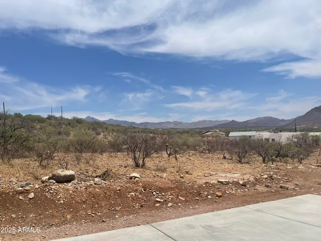 a view of a road with mountains in the background