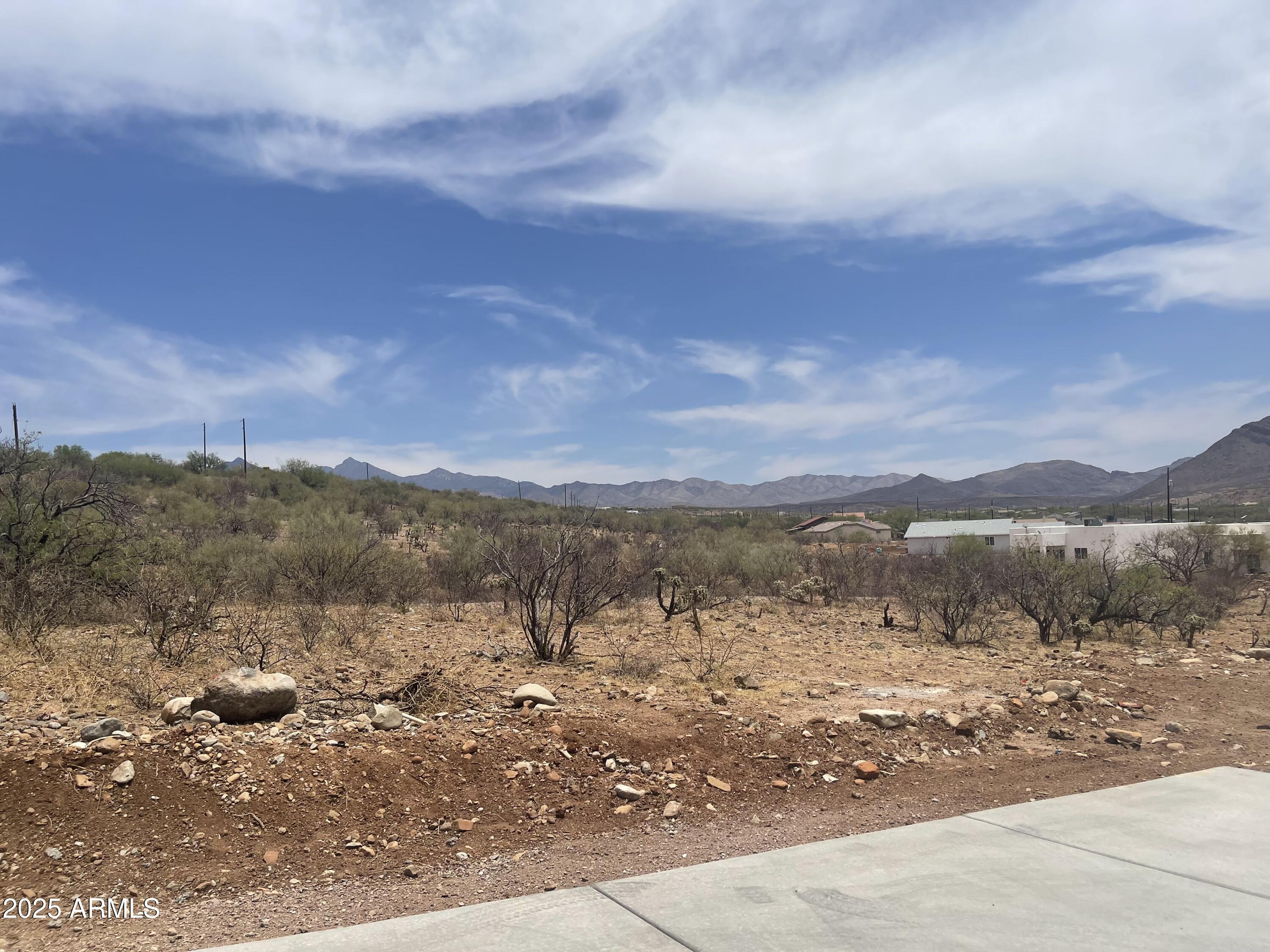 1858 Circulo Glorieta, Unit 309 Rio Rico, AZ 85648 - Photo 4 of 7 a view of a road with mountains in the background
