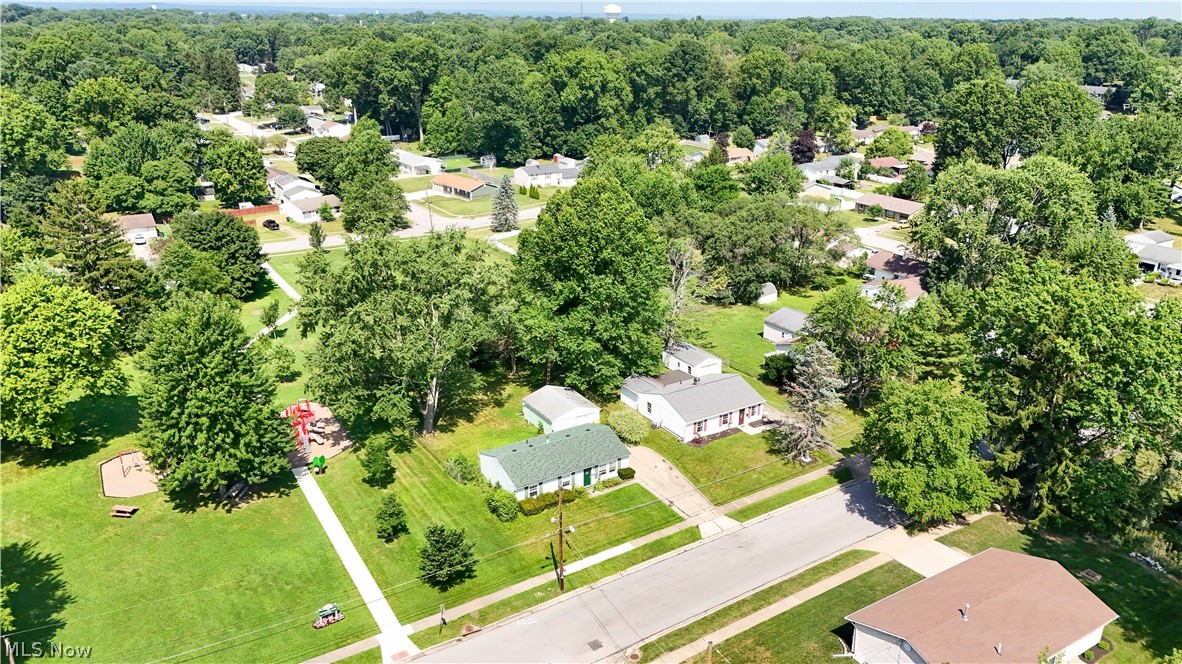 3796 North Santom Road Stow, OH 44224 - Photo 28 of 30 Expansive green space with mature trees, paved pathways, and recreational equipment