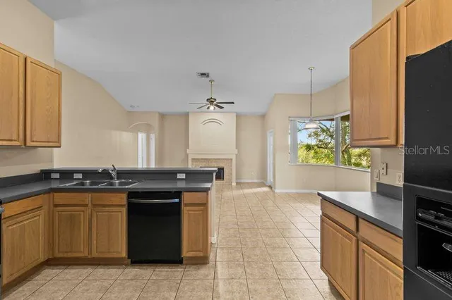a kitchen with stainless steel appliances granite countertop a refrigerator sink and cabinets