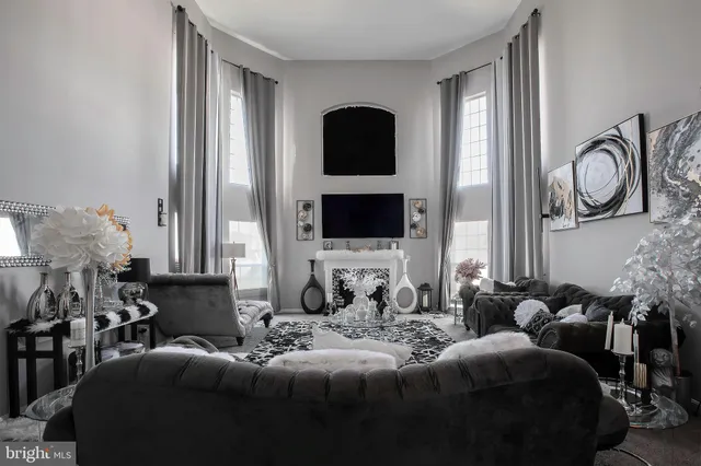 a living room with furniture and a large mirror