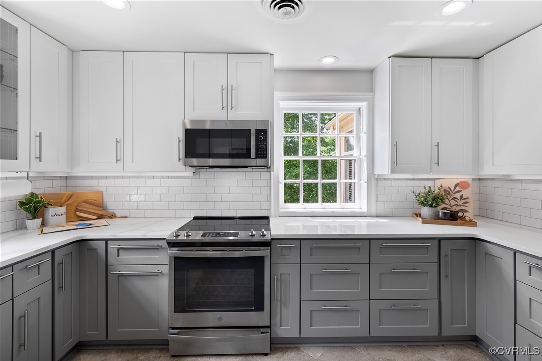 6161 River Road Richmond, VA 23226 - Photo 12 of 38 a kitchen with granite countertop white cabinets and appliances