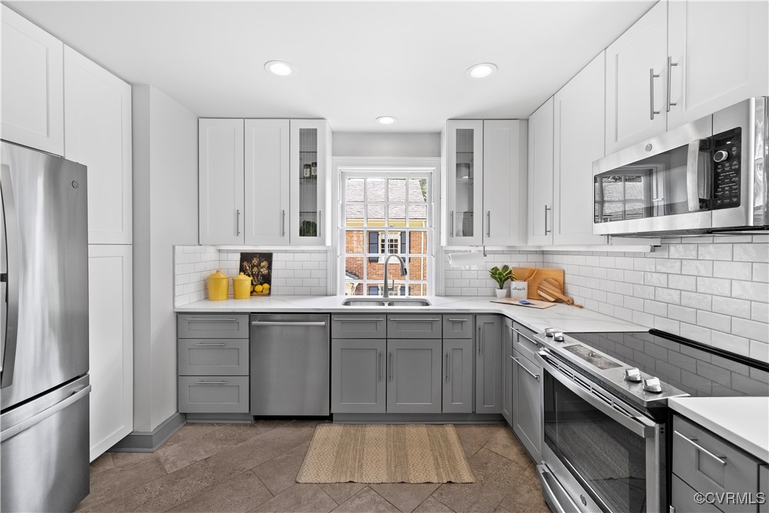 6161 River Road Richmond, VA 23226 - Photo 9 of 38 a kitchen with stainless steel appliances granite countertop a stove sink and cabinets