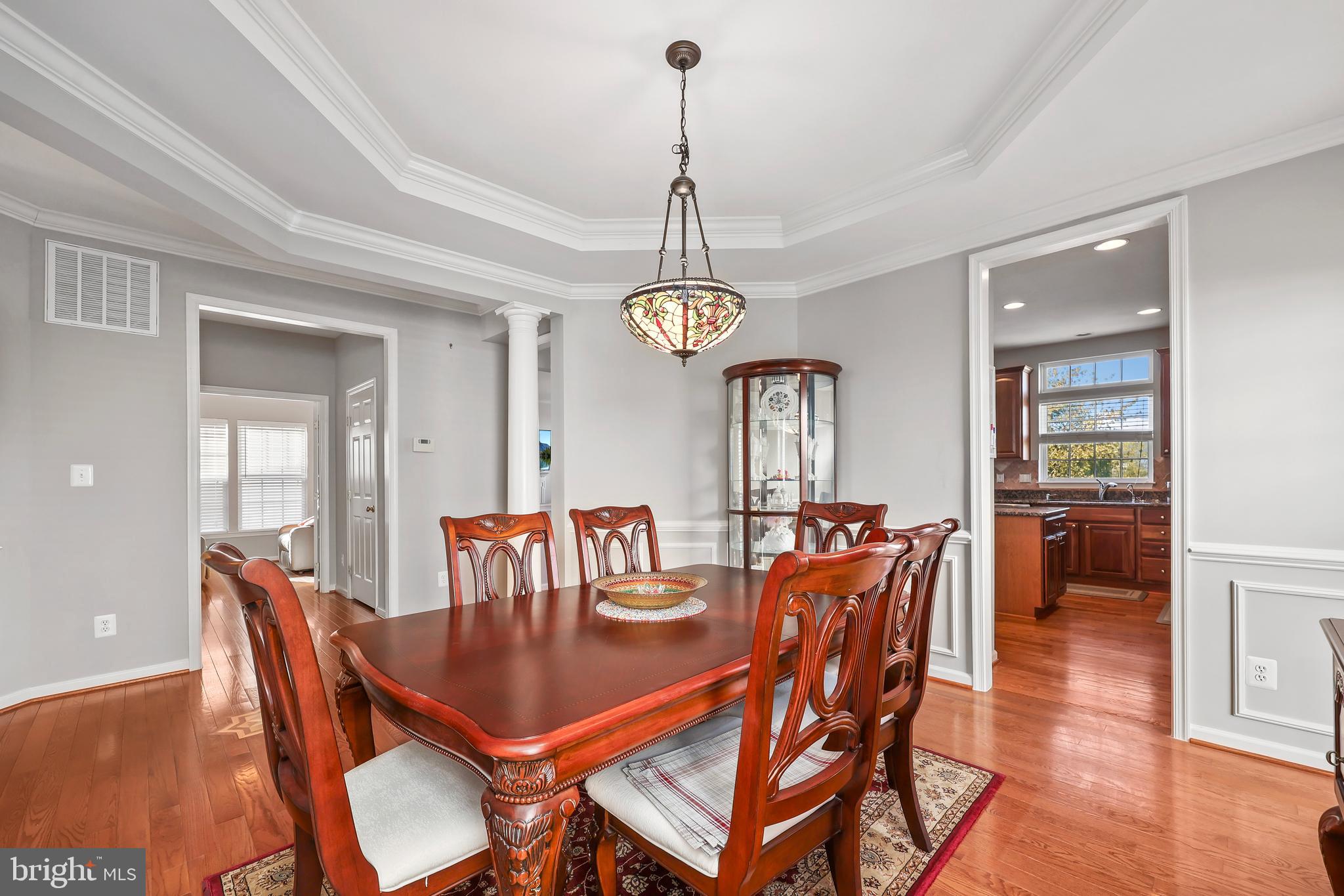 41742 Experience Way Aldie, VA 20105 - Photo 11 of 78 a dining room with furniture a chandelier and wooden floor