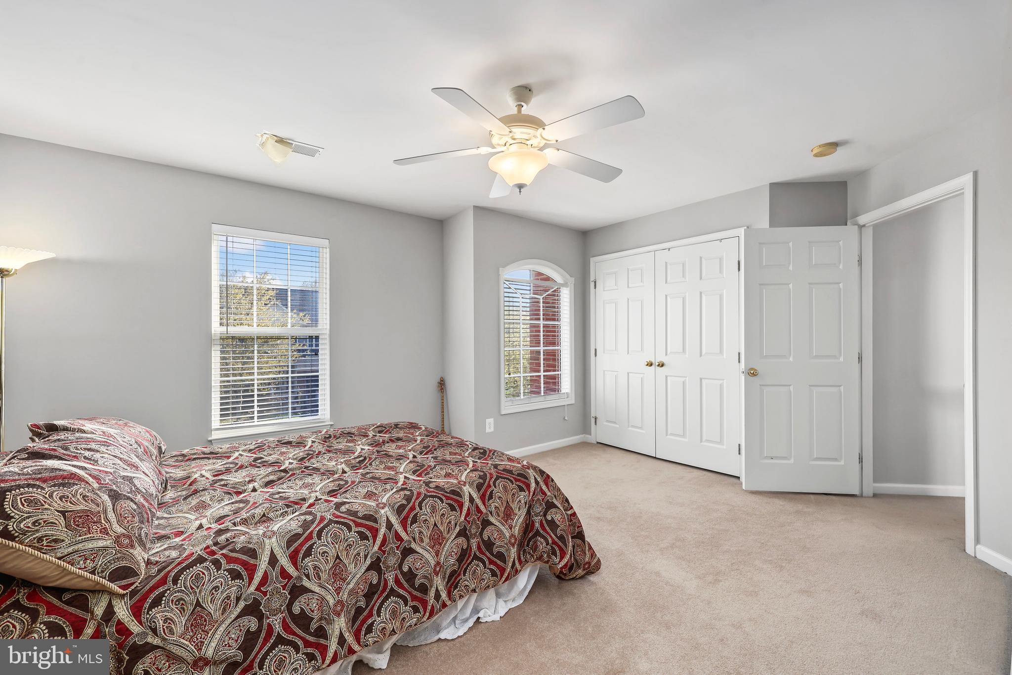 41742 Experience Way Aldie, VA 20105 - Photo 26 of 78 a spacious bedroom with a large bed and a chandelier