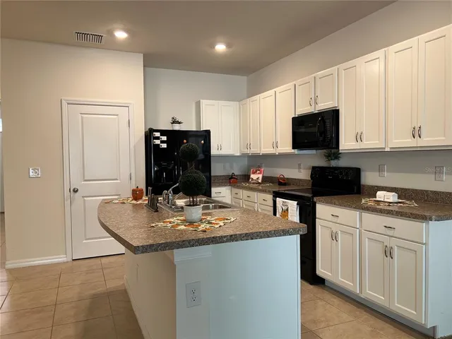 a kitchen with a sink and a stove top oven