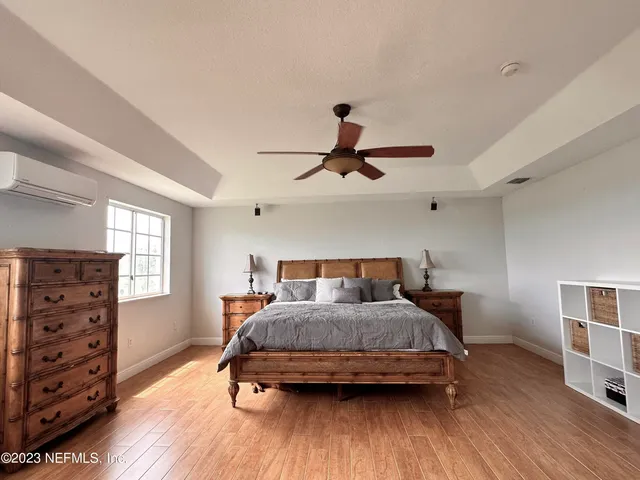 a living room with a couch and a table with wooden floor