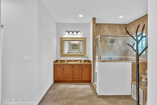 a bathroom with a tub sink and mirror