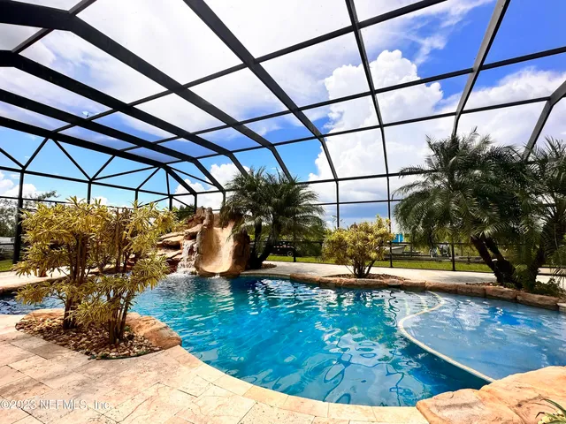 a view of a chairs and table in the backyard