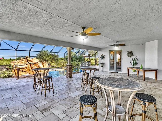 a sign board with yard and trees