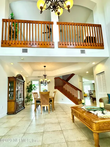 a living room with furniture and potted plants