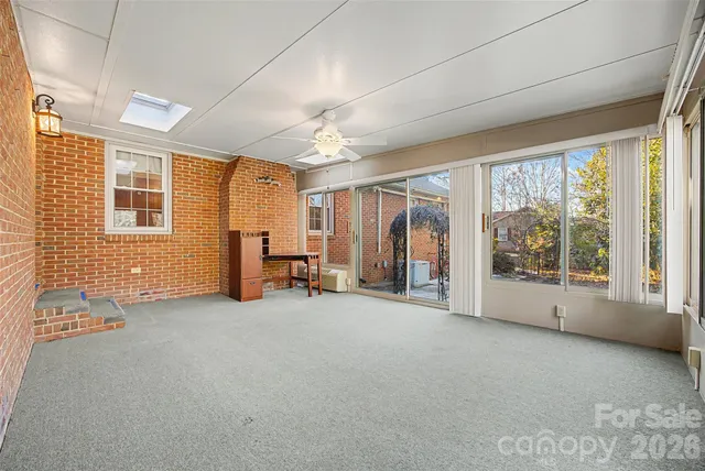 a view of a yard with plants and trees