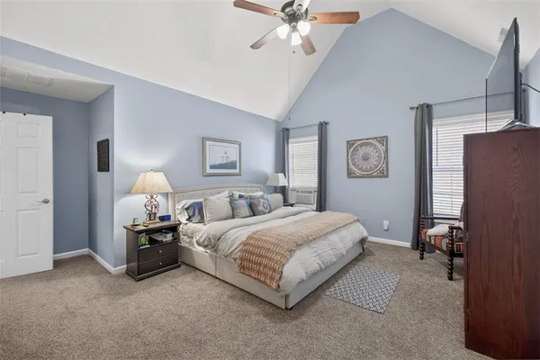 a bedroom with bed and a chandelier
