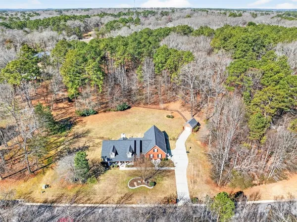 an aerial view of a house with a yard
